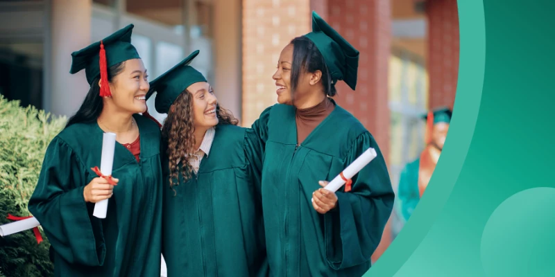 Three diverse female students in forest green graduation gowns and caps smile and celebrate together while holding their rolled diplomas. The image features a vibrant teal and green curved graphic on the right side.