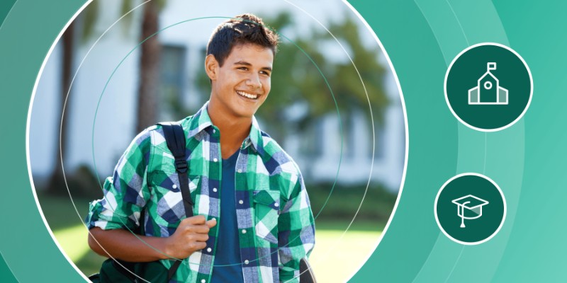 Smiling male student with a backpack walking on a university campus